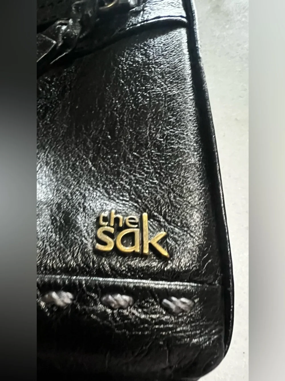 The Sak Black Leather Crossbody Bag with Gold Hardware And Colorful Lining